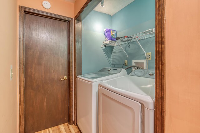 713 Taneycomo Rd, Branson, MO 65616 - laundry room with washer and dryer and wood finished floors