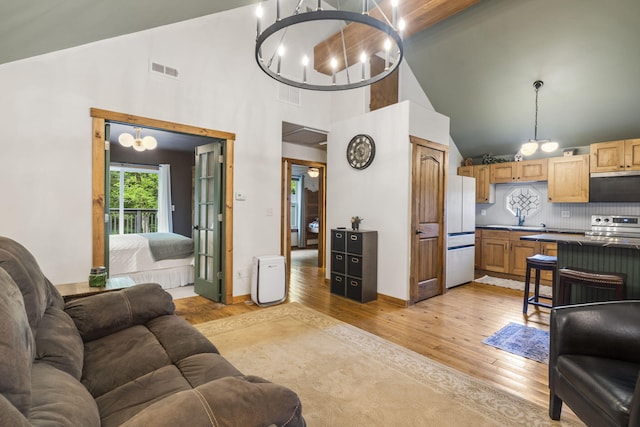 1226 Peace In Valley Rd, Blue Eye, MO 65611 - living room with a chandelier, high vaulted ceiling, and light wood-style floors