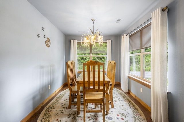 1226 Peace In Valley Rd, Blue Eye, MO 65611 - dining area with a chandelier, wood finished floors, and baseboards