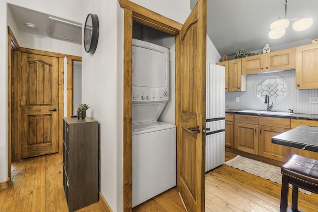 1226 Peace In Valley Rd, Blue Eye, MO 65611 - laundry area featuring stacked washing machine and dryer and light wood-style floors