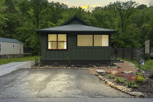 1226 Peace In Valley Rd, Blue Eye, MO 65611 - view of front of property with board and batten siding, fence, metal roof, and a wooded view