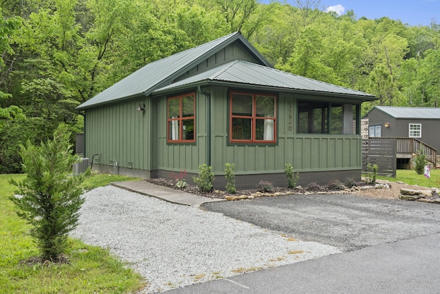 1226 Peace In Valley Rd, Blue Eye, MO 65611 - view of side of home featuring a forest view, board and batten siding, metal roof, and cooling unit