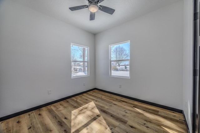 834 Morris St, Mountain Grove, MO 65711 - empty room featuring wood finished floors, a ceiling fan, and baseboards