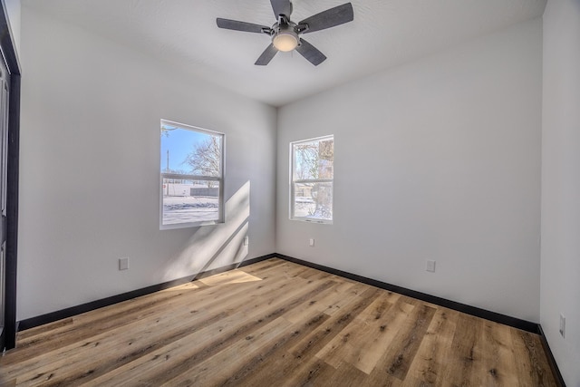 834 Morris St, Mountain Grove, MO 65711 - unfurnished room with wood finished floors, baseboards, and a ceiling fan