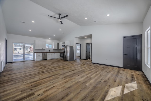 834 Morris St, Mountain Grove, MO 65711 - unfurnished living room featuring high vaulted ceiling, a ceiling fan, wood finished floors, recessed lighting, and a sink