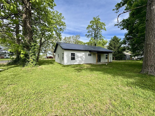 834 Morris St, Mountain Grove, MO 65711 - rear view of property featuring a yard, metal roof, and a patio area