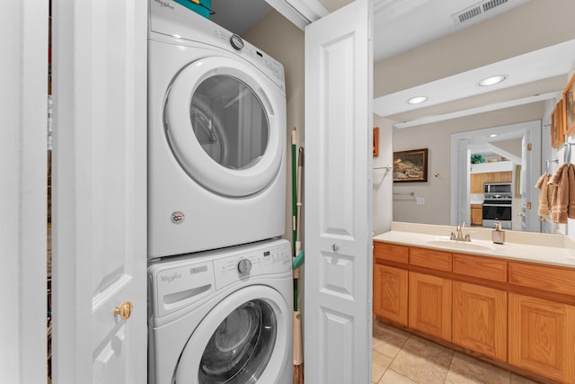 351 Wildwood Dr S Unit 5, Branson, MO 65616 - clothes washing area with stacked washer and clothes dryer, recessed lighting, and light tile patterned flooring