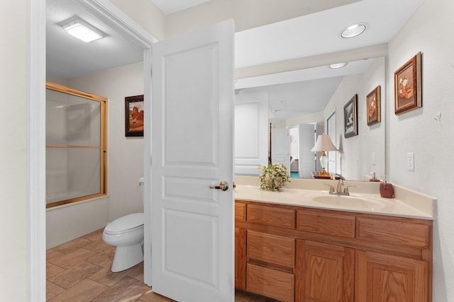 351 Wildwood Dr S Unit 5, Branson, MO 65616 - bathroom with toilet, vanity, stone finish flooring, and enclosed tub / shower combo