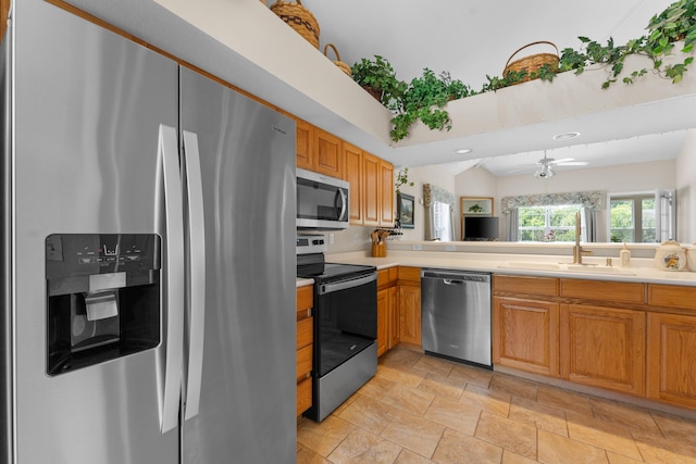 351 Wildwood Dr S Unit 5, Branson, MO 65616 - kitchen featuring stainless steel appliances, a sink, light countertops, ceiling fan, and brown cabinetry