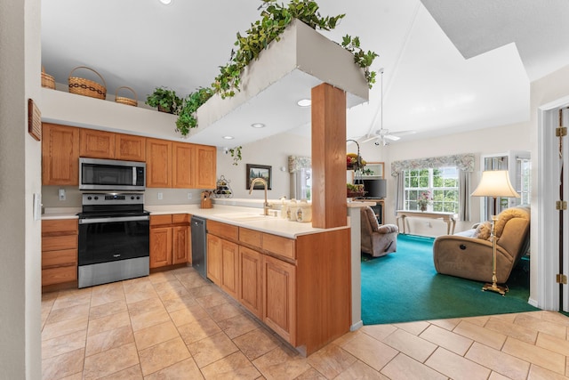 351 Wildwood Dr S Unit 5, Branson, MO 65616 - kitchen featuring appliances with stainless steel finishes, a sink, open floor plan, light countertops, and vaulted ceiling