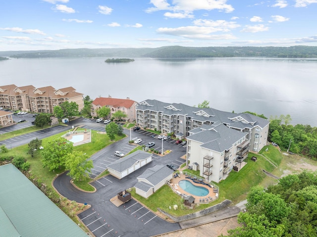 680 Emerald Pointe Dr Unit 6, Hollister, MO 65672 - drone / aerial view of a pool area, a nearby body of water, and apartment complex