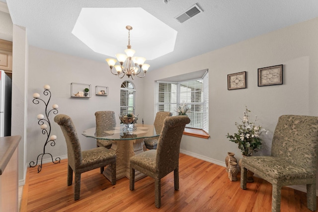 680 Emerald Pointe Dr Unit 6, Hollister, MO 65672 - dining room featuring a chandelier, light wood-type flooring, baseboards, and a skylight