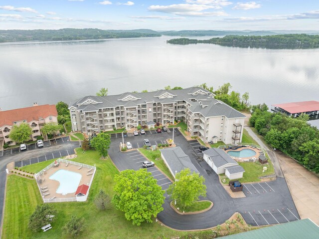 680 Emerald Pointe Dr Unit 6, Hollister, MO 65672 - bird's eye view of a pool, a nearby body of water, and apartment complex