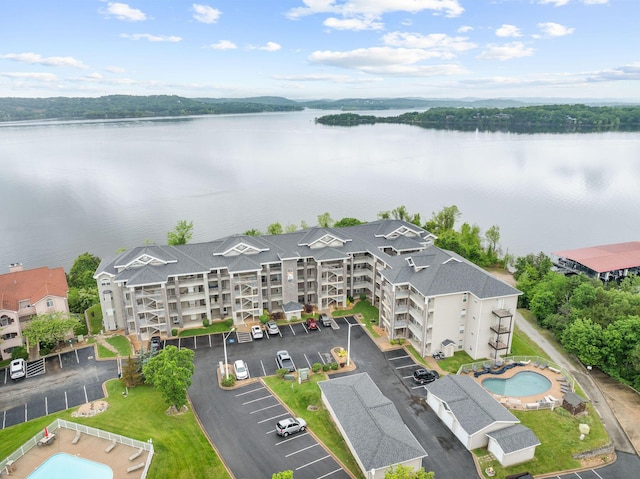 680 Emerald Pointe Dr Unit 6, Hollister, MO 65672 - drone / aerial view of a pool area, a nearby body of water, and apartment complex / building