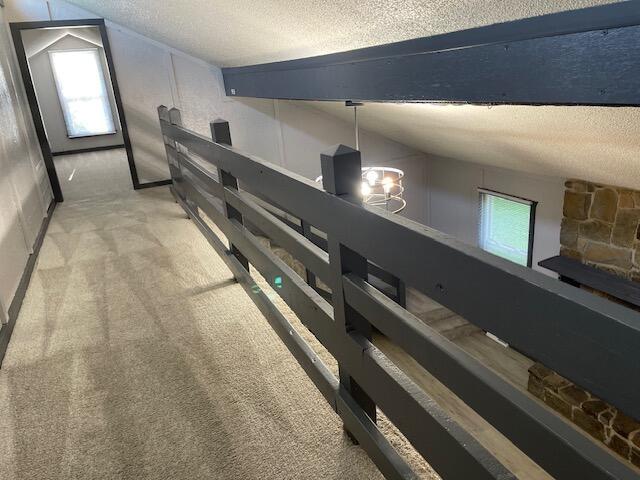 1627 W Lindberg St, Springfield, MO 65807 - hall featuring a textured ceiling, plenty of natural light, vaulted ceiling, and carpet flooring