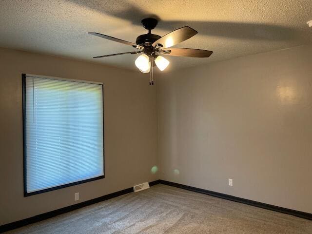 1627 W Lindberg St, Springfield, MO 65807 - spare room with ceiling fan, carpet floors, a textured ceiling, and baseboards