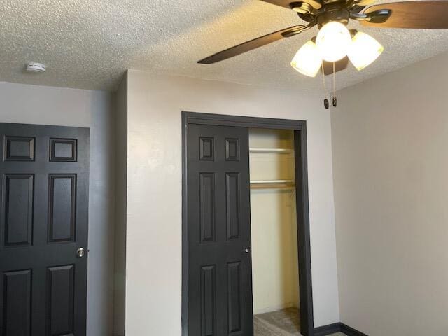 1627 W Lindberg St, Springfield, MO 65807 - unfurnished bedroom with a textured ceiling, a closet, and a ceiling fan