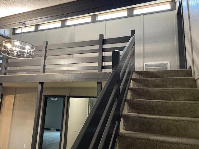 1627 W Lindberg St, Springfield, MO 65807 - staircase featuring a chandelier