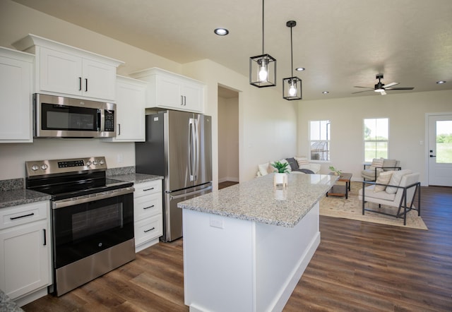 13320 E 1424th Rd, Stockton, MO 65785 - kitchen with appliances with stainless steel finishes, dark wood-style floors, a center island, white cabinets, and recessed lighting
