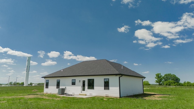 13320 E 1424th Rd, Stockton, MO 65785 - back of property featuring a lawn, central AC unit, and roof with shingles