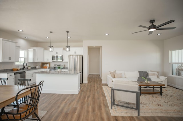 13320 E 1424th Rd, Stockton, MO 65785 - living area featuring light wood-style floors, recessed lighting, baseboards, and ceiling fan