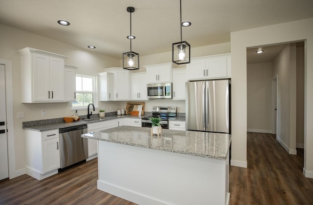 13320 E 1424th Rd, Stockton, MO 65785 - kitchen featuring appliances with stainless steel finishes, a sink, dark wood-style floors, white cabinets, and a center island