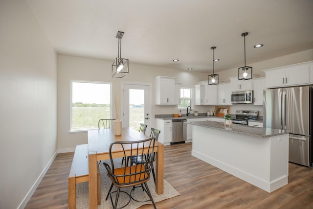 13320 E 1424th Rd, Stockton, MO 65785 - kitchen featuring appliances with stainless steel finishes, a kitchen island, recessed lighting, white cabinets, and wood finished floors