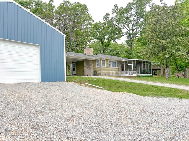 106 Blue Ridge Dr, Theodosia, MO 65761 - view of front of home featuring a chimney, a sunroom, a garage, and a front yard