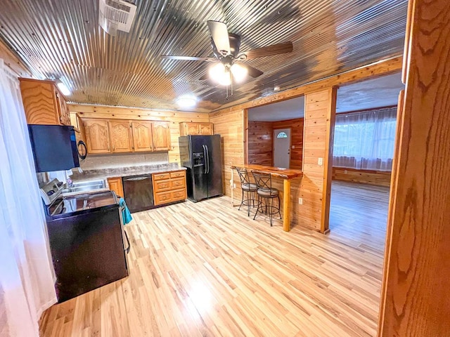 106 Blue Ridge Dr, Theodosia, MO 65761 - kitchen with black appliances, wood walls, a ceiling fan, light wood-style floors, and light countertops