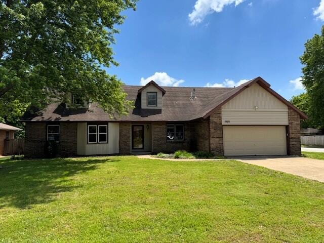 3820 S Virginia Pl, Springfield, MO 65807 - view of front of property featuring concrete driveway, a garage, and brick siding