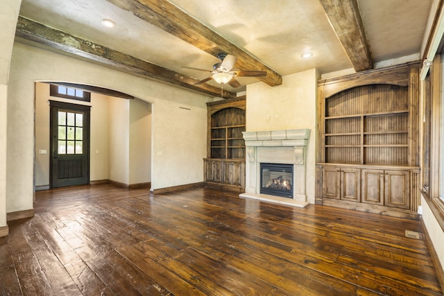 3260 W Rivulet Pass, Springfield, MO 65810 - unfurnished living room featuring hardwood / wood-style floors, beam ceiling, ceiling fan, a glass covered fireplace, and built in shelves