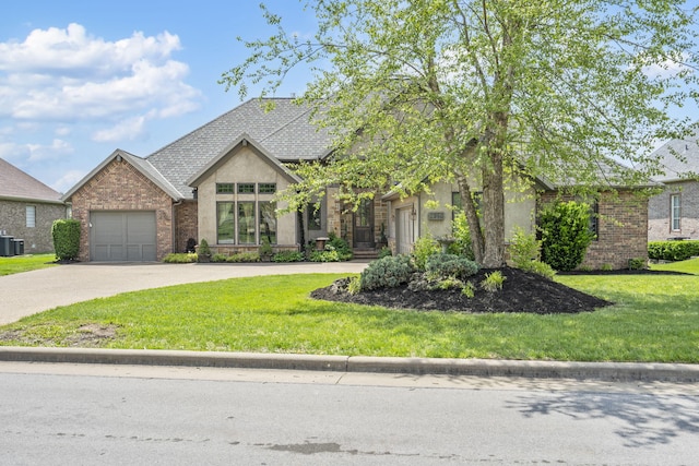 3260 W Rivulet Pass, Springfield, MO 65810 - french country inspired facade with driveway, a front lawn, stucco siding, a garage, and cooling unit