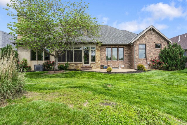 3260 W Rivulet Pass, Springfield, MO 65810 - rear view of property with entry steps, a lawn, a patio area, and brick siding