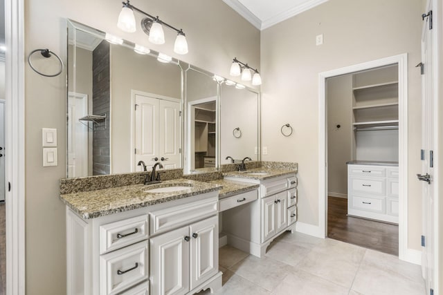 3260 W Rivulet Pass, Springfield, MO 65810 - full bathroom featuring ornamental molding, vanity, a spacious closet, tile patterned floors, and baseboards