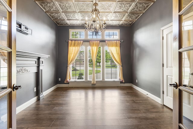 3260 W Rivulet Pass, Springfield, MO 65810 - unfurnished dining area featuring an ornate ceiling, a chandelier, dark wood-type flooring, baseboards, and french doors