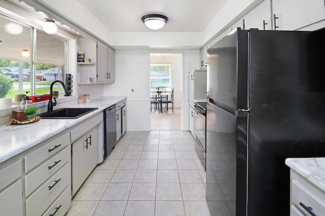 845 W Seminole St, Springfield, MO 65807 - kitchen featuring freestanding refrigerator, a sink, dishwasher, light tile patterned floors, and open shelves
