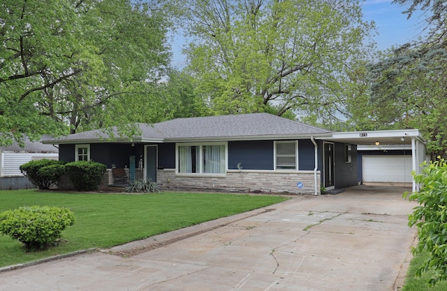 845 W Seminole St, Springfield, MO 65807 - ranch-style house with a front yard, driveway, an attached carport, a shingled roof, and stone siding