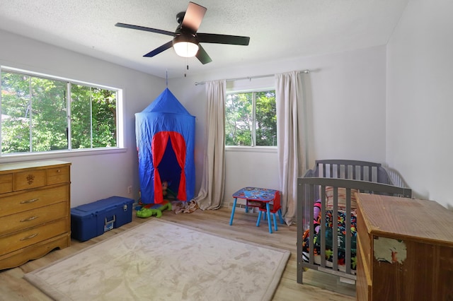 845 W Seminole St, Springfield, MO 65807 - bedroom featuring wood finished floors, a ceiling fan, and a textured ceiling