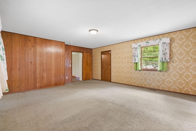 191 State Highway Y, Forsyth, MO 65653 - spare room featuring carpet flooring, wooden walls, and wallpapered walls