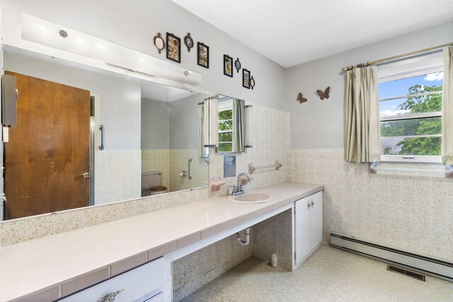191 State Highway Y, Forsyth, MO 65653 - full bath featuring tile walls, vanity, a wainscoted wall, and a baseboard heating unit