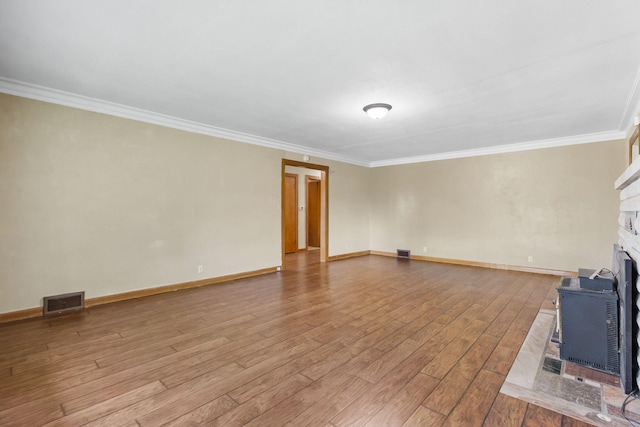 191 State Highway Y, Forsyth, MO 65653 - unfurnished living room with crown molding, wood finished floors, baseboards, a fireplace, and a wood stove