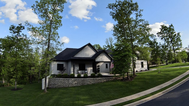 modern farmhouse with a front lawn and board and batten siding