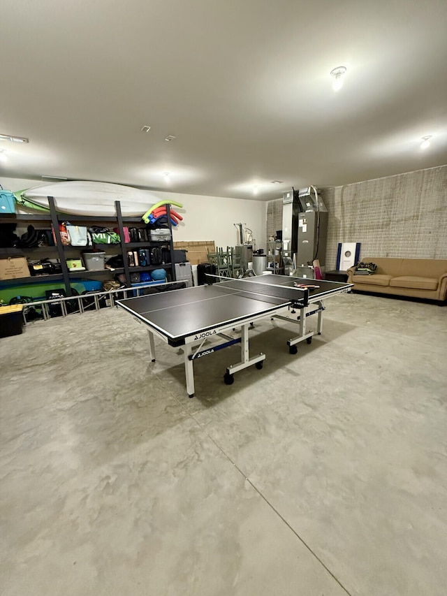 game room featuring concrete floors and heating unit