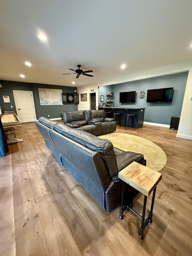 living area with wood finished floors, recessed lighting, ceiling fan, and baseboards