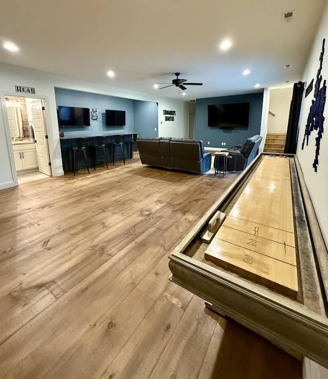 recreation room with ceiling fan, light wood finished floors, and recessed lighting