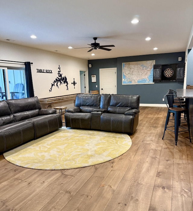 living area with hardwood / wood-style flooring, ceiling fan, and recessed lighting