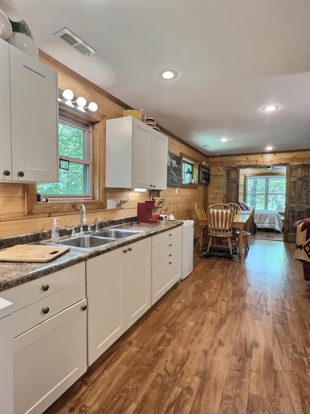 1424 Brown Rd, Van Buren, MO 63965 - kitchen with a sink, white cabinets, wood finished floors, wooden walls, and recessed lighting