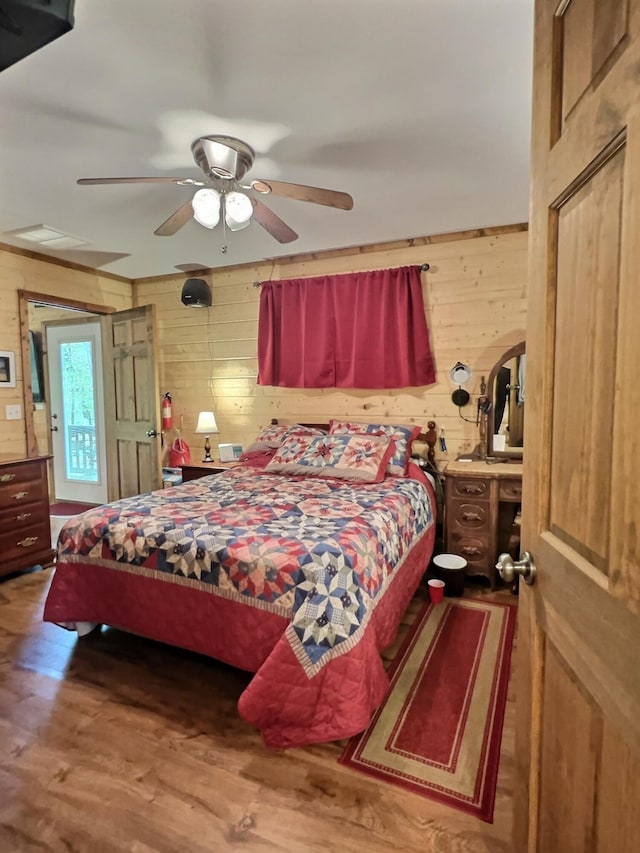 1424 Brown Rd, Van Buren, MO 63965 - bedroom featuring wood walls, wood finished floors, and ceiling fan