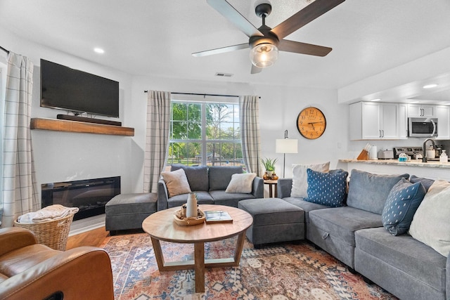 77 Anglers Pointe Unit 4, Branson, MO 65616 - living area featuring a ceiling fan, wood finished floors, a glass covered fireplace, and recessed lighting