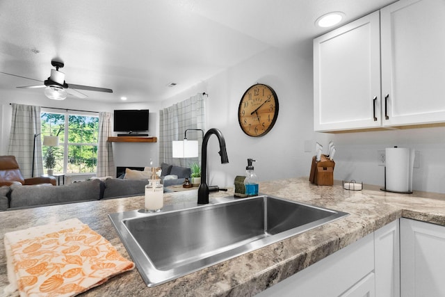 77 Anglers Pointe Unit 4, Branson, MO 65616 - kitchen with a sink, white cabinets, ceiling fan, light countertops, and open floor plan